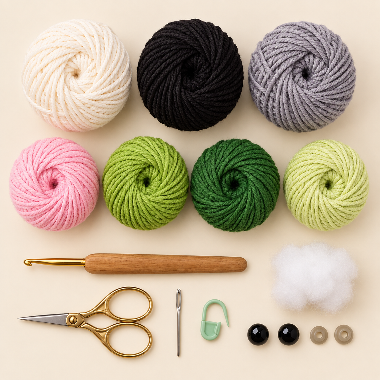 Materials for panda crochet pattern with bamboo including cotton yarn, crochet hook, stuffing, safety eyes, and sewing tools